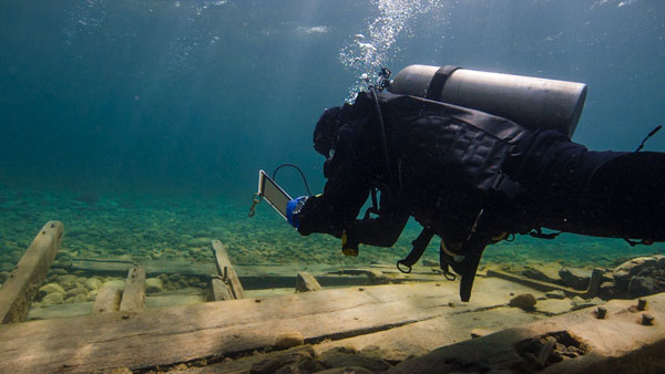 Research diver taking notes over Alvin Buckingham