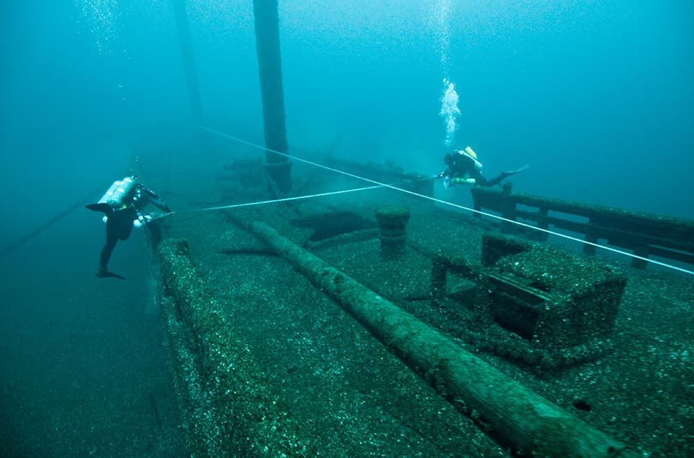 two divers documenting the wreck of the defiance