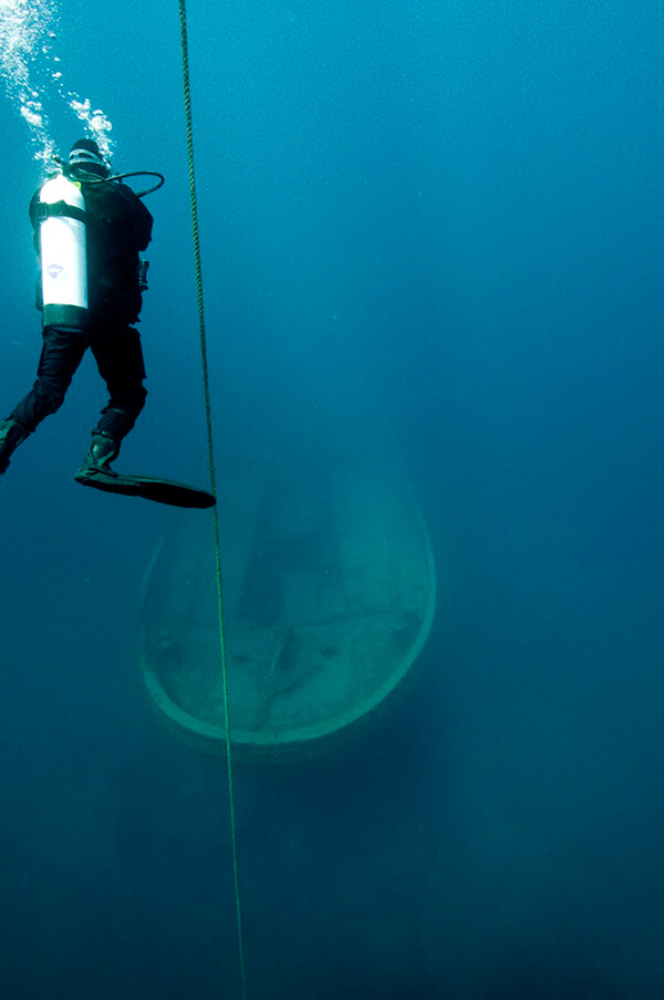 a dA diver floats over a shipwreck
