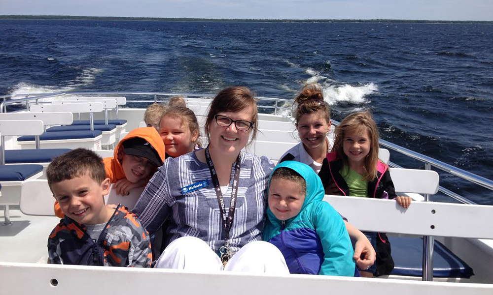 teacher and students on a boat tour