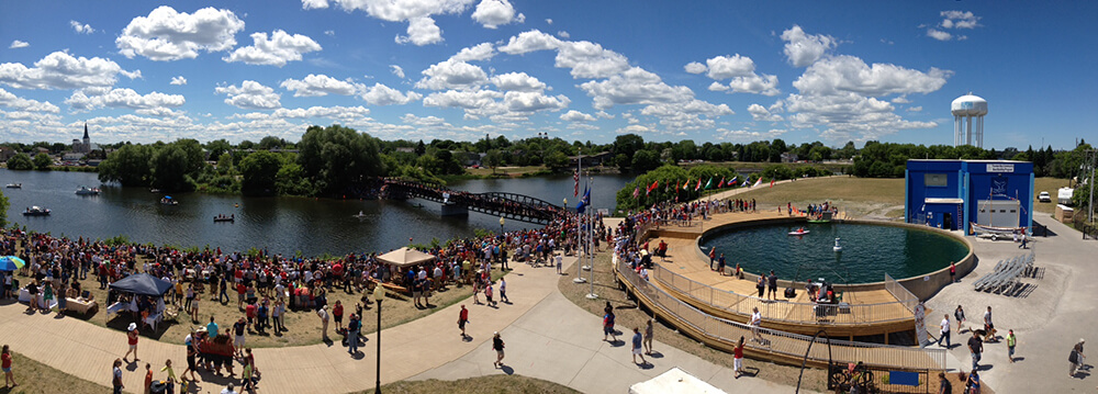 a panorama of a crowd gathering near a river