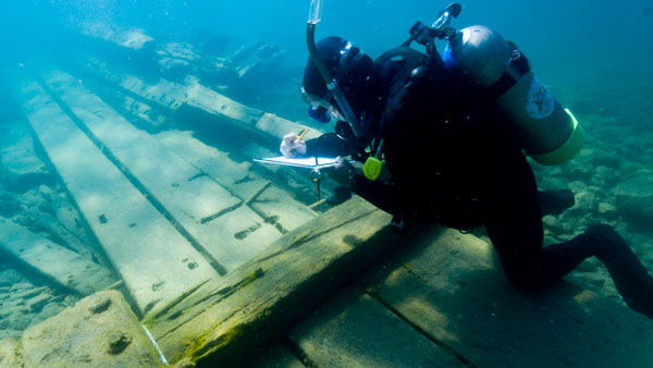 Research diver taking notes on American Union