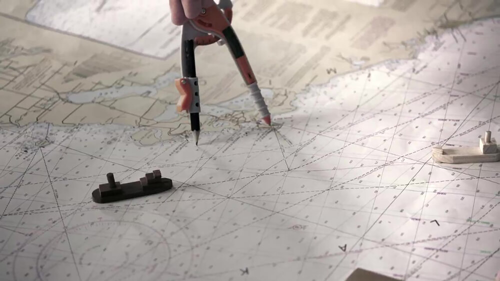 A map with ship figurines resting on it
