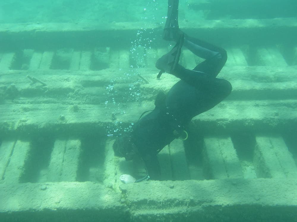 A snorkeler explores the site of the sunken barge Detroit
