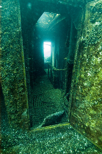 A doorway into a small room of a shipwreck