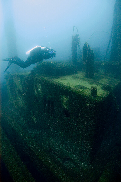 A diver inspects a shipwreck