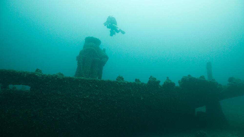 A diver floats above a shipwreck