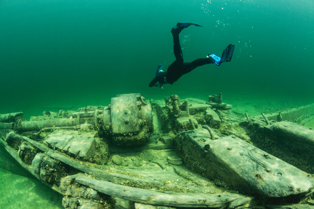 a snorkelers swims above a shipwreck