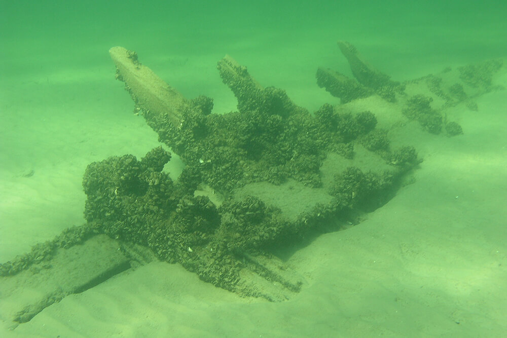 parts of a shipwreck rest on a lake bed