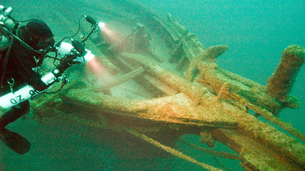 A diver hovers above a shipwreck