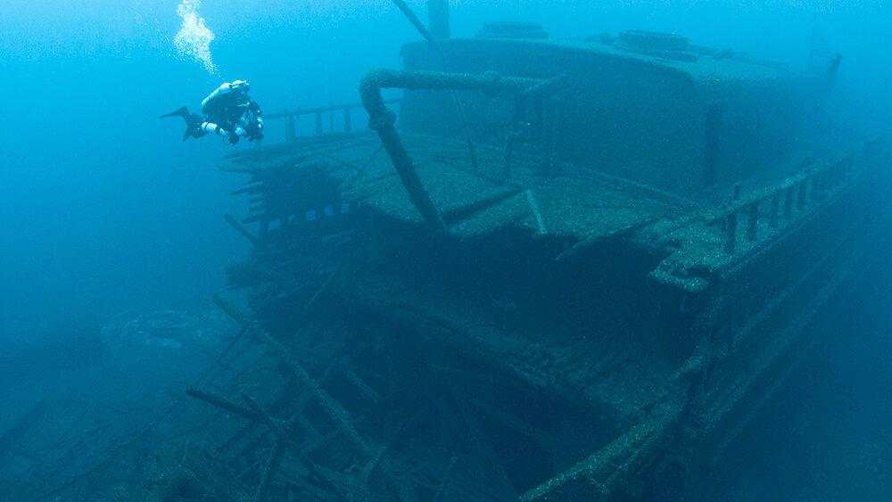 A shipwreck broken in half allowing view into the hull