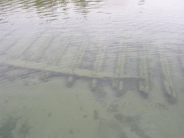 Wooden wreckage from the Gilchrist Fleet, visible from the surface.