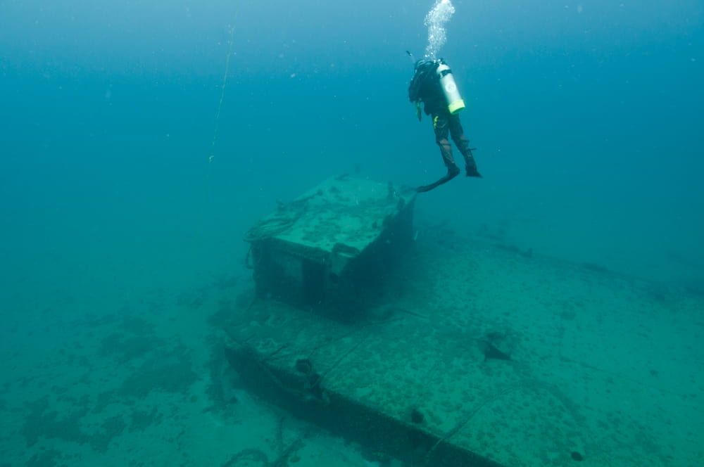 A diver examining the wreck of Steel Barge ship