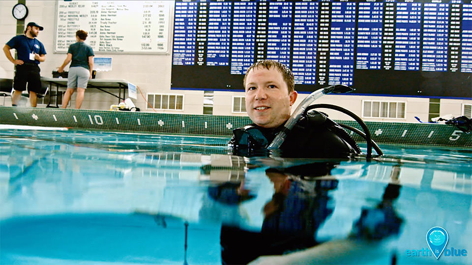 a person in a pool in diving gear